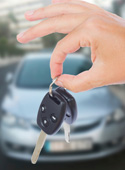 Hand holding keys to new car